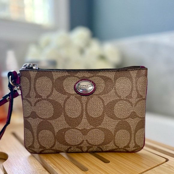 Coach Handbags - Coach Brown Signature Canvas Wristlet with Plum Trim